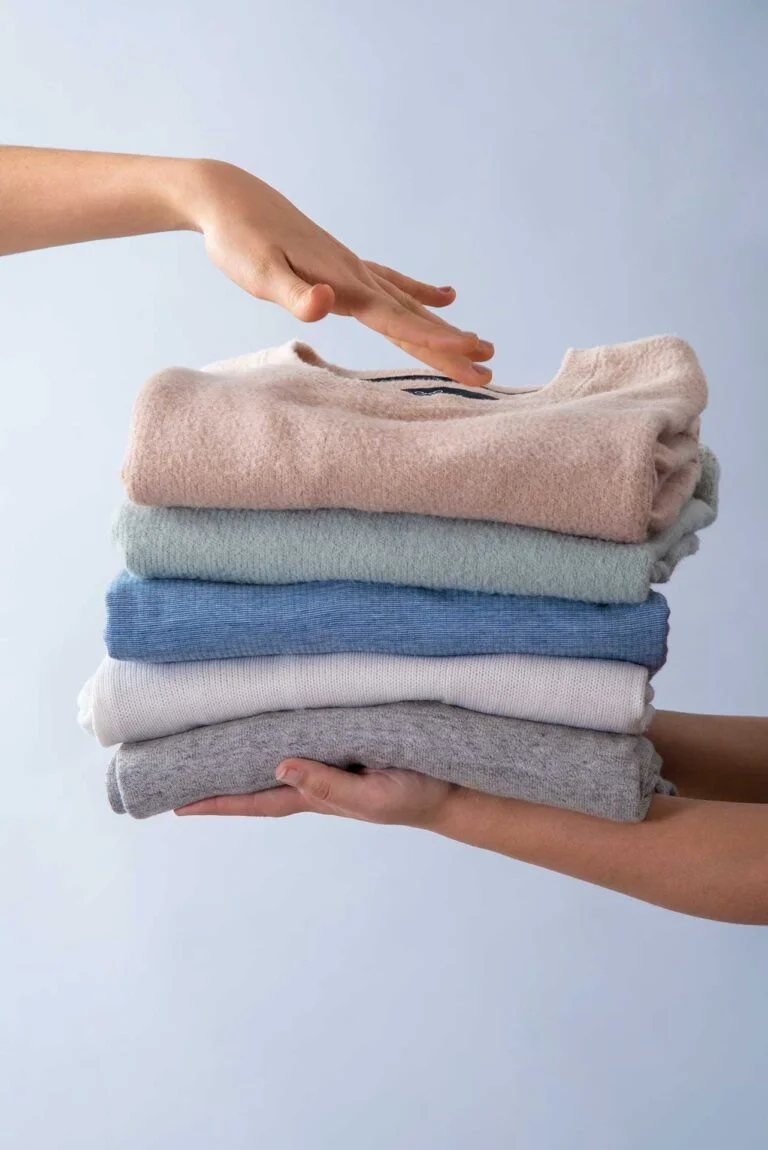 Neatly stacked clean clothes representing quality wash and fold service