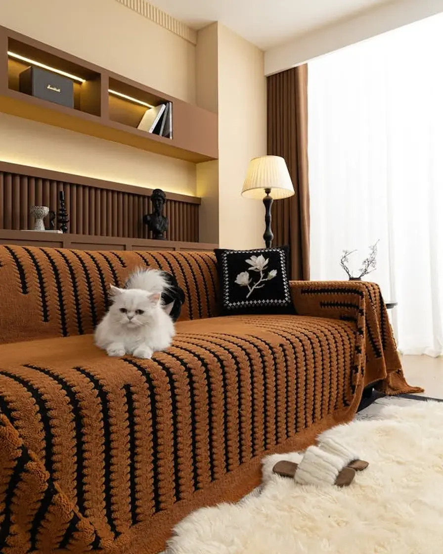 Rust ribbed cover fitted over a brown sofa in a bright living room, sofa cover cleaning for Al Darari